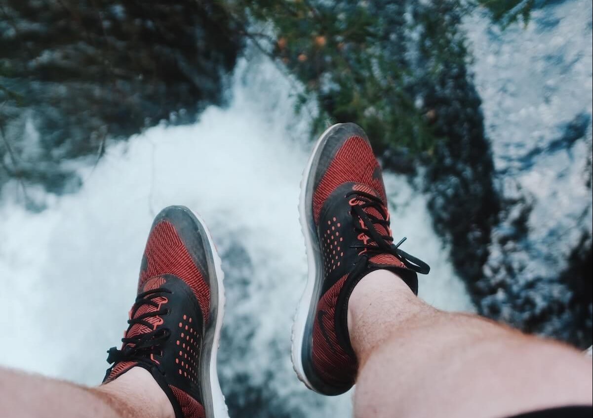 man feet over waterfall