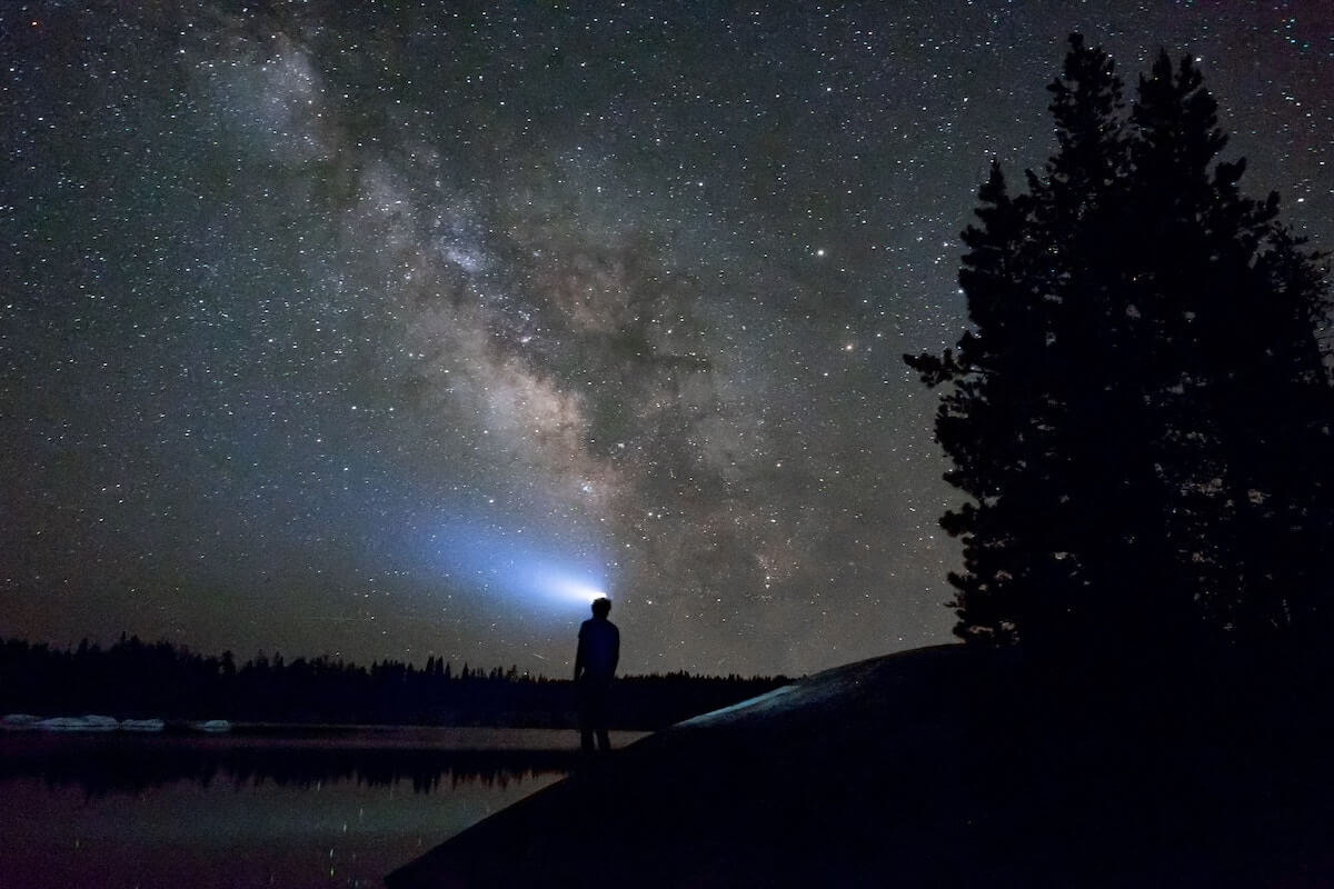 man near lake in night