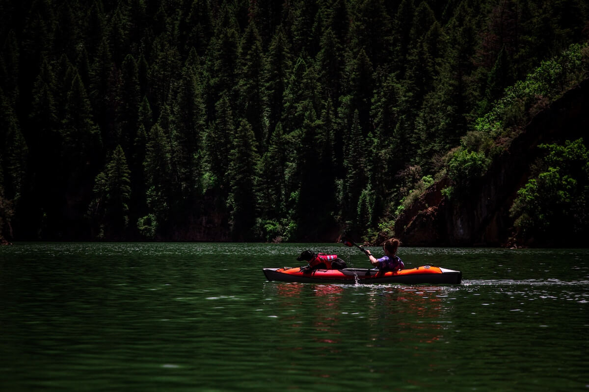 women and dog in kayak