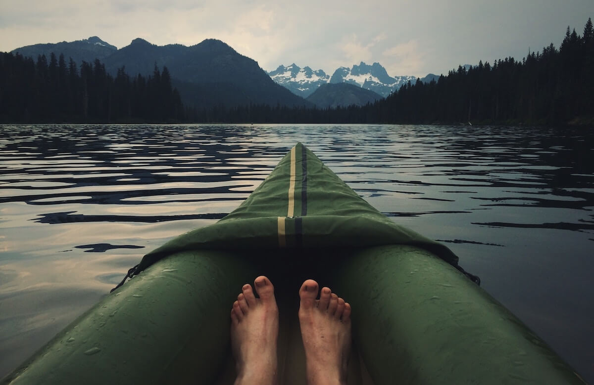 persons feet in a green kayak